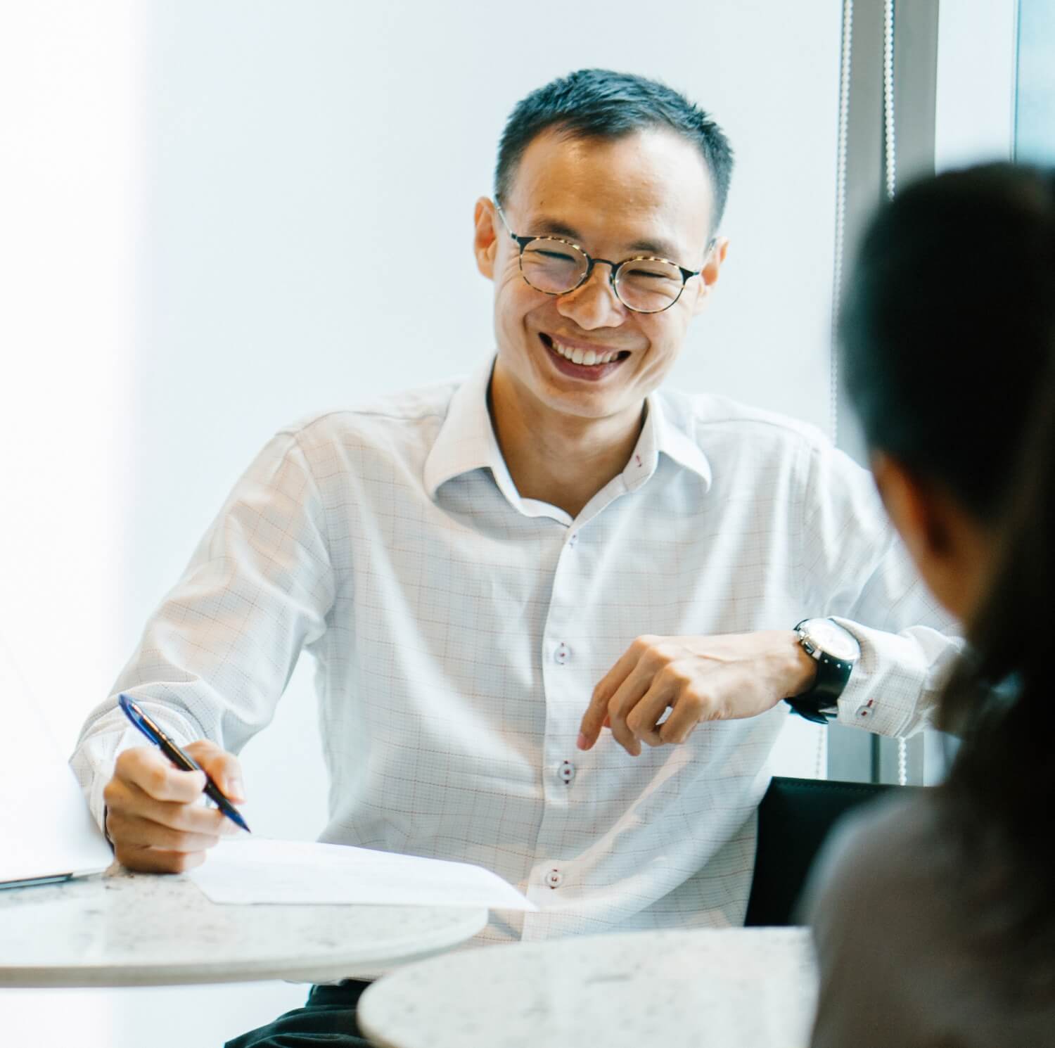 A man laughing during business discussions